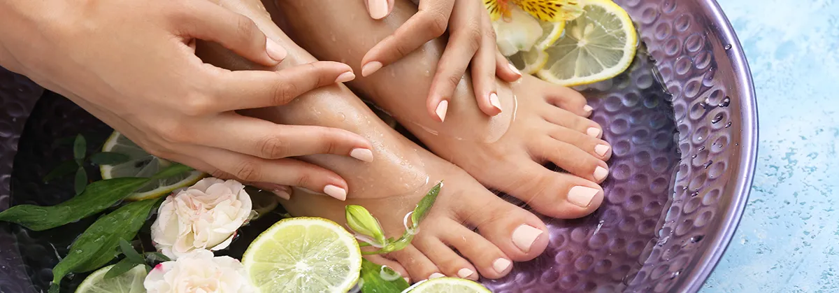 Young woman undergoing spa pedicure treatment in beauty salon